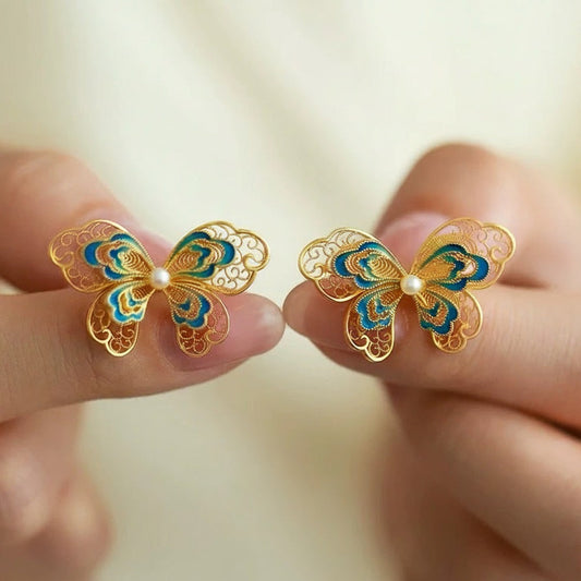 Gold-plated silver butterfly earrings crafted with filigree inlay, handmade jewelry symbolizing freedom and beauty in an oriental aesthetic.