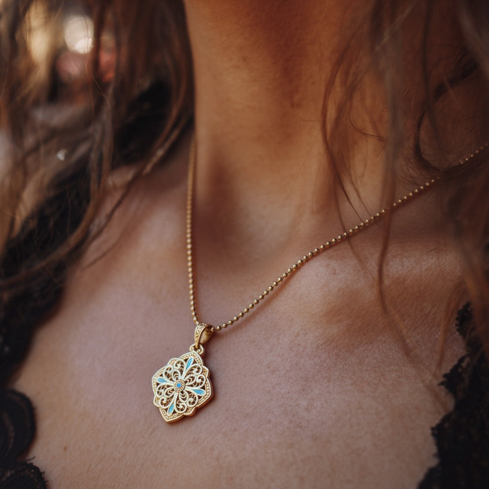 Pendant combining delicate hollow silverwork with smooth enamel — a balanced piece of Chinese enamel jewelry suitable for layering or gifting.