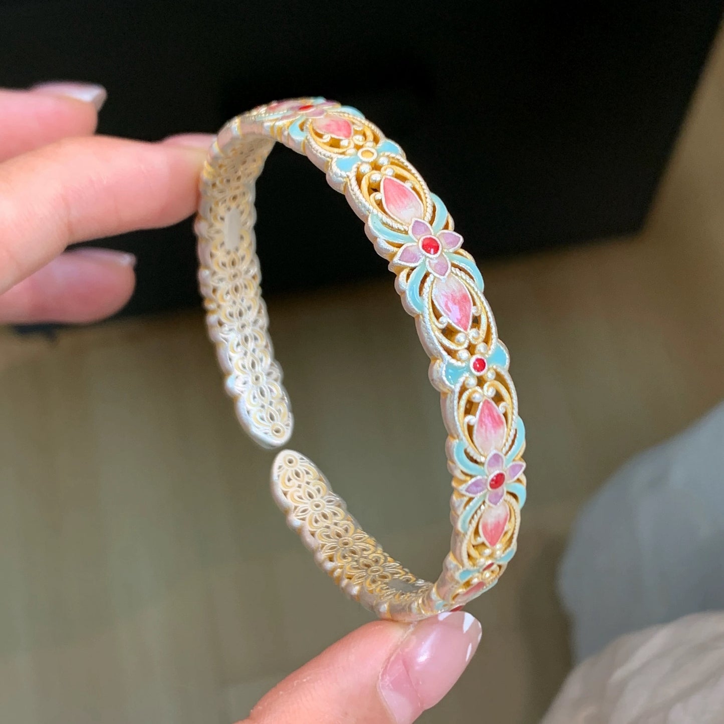Handmade bracelet using filigree and enamel techniques, blooming with intricate floral patterns — a piece of Chinese enamel jewelry.
