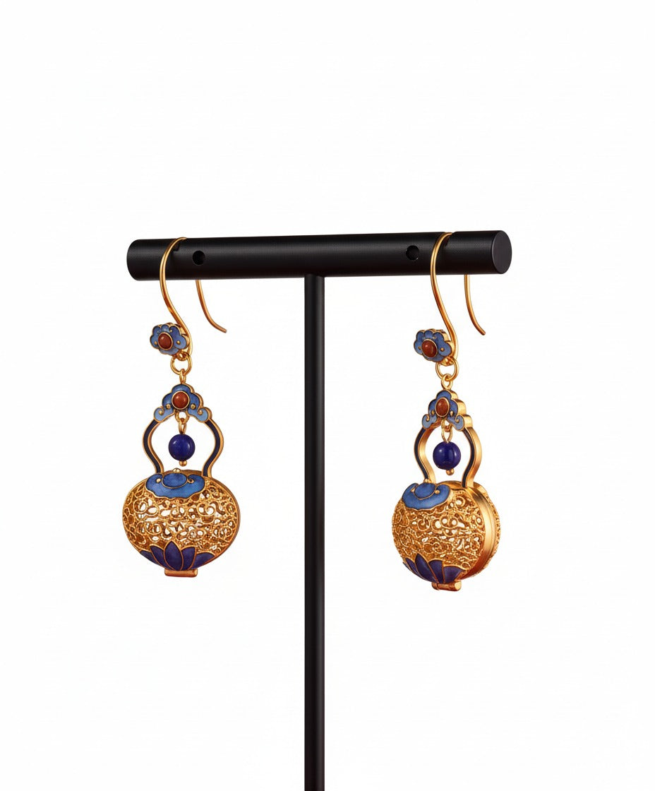 Handcrafted filigree silver earrings featuring gourd motif — meticulous detail that carries blessings of luck and prosperity.
