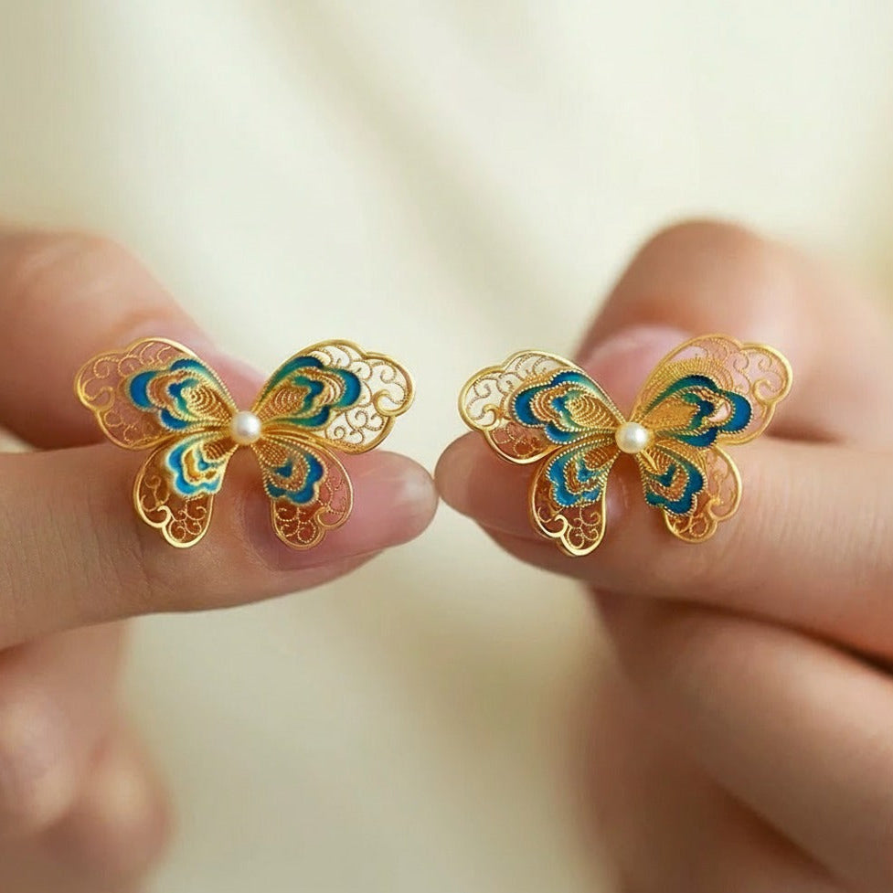 Gold-plated silver butterfly earrings crafted with filigree inlay, handmade jewelry symbolizing freedom and beauty in an oriental aesthetic.