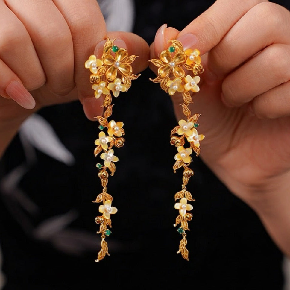 Handmade silver earrings with osmanthus filigree inlay and elegant tassels, traditional handmade silver jewelry ideal for festive wear or gifting.