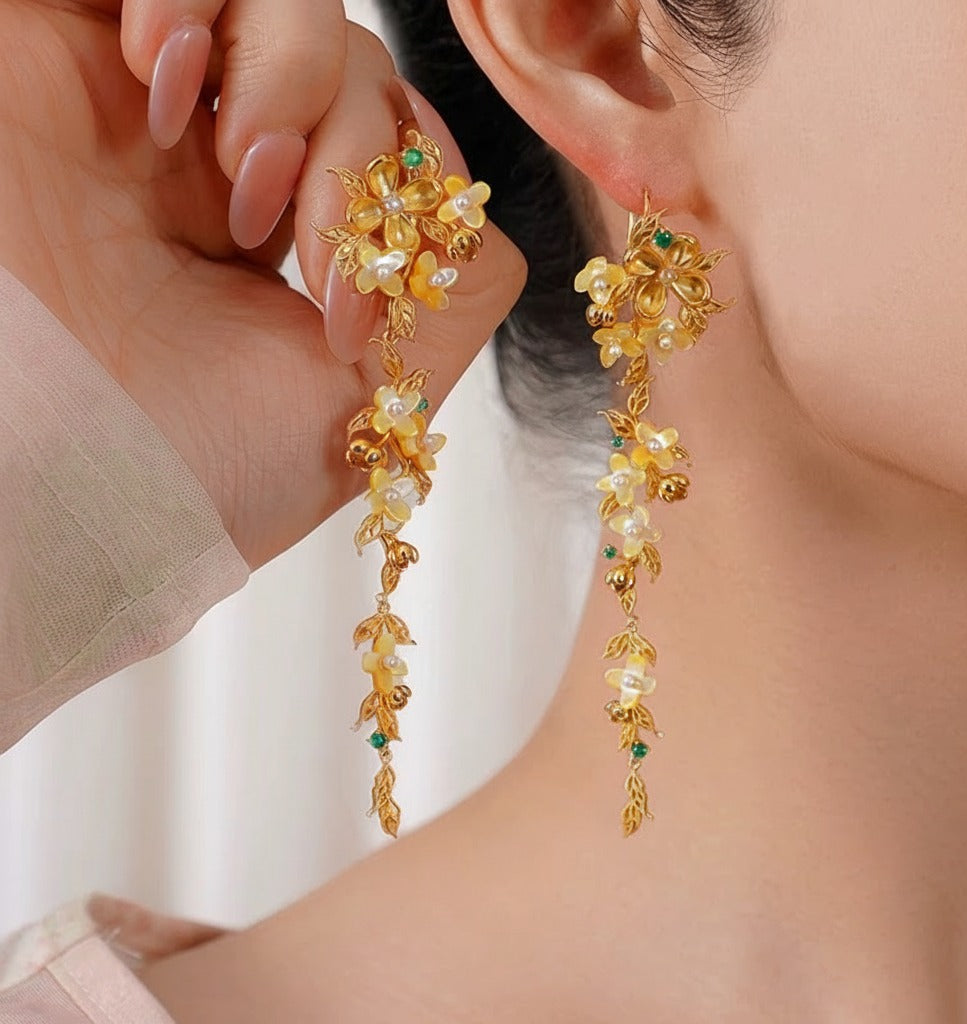 Handmade silver earrings with osmanthus filigree inlay and elegant tassels, traditional handmade silver jewelry ideal for festive wear or gifting.